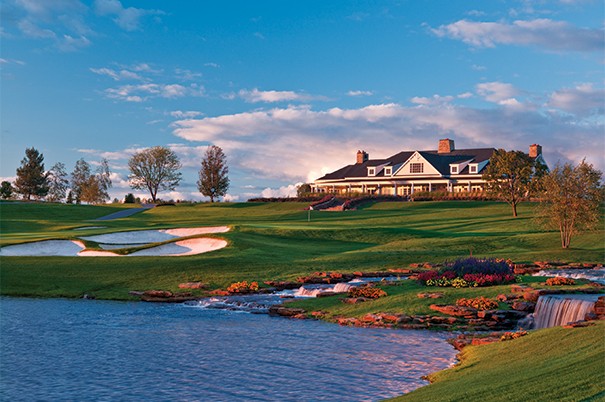 Panoramic view of Atunyote and Clubhouse with streams falling in to pond in evening sunlight