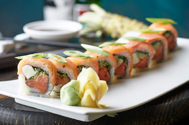 uramaki sushi rainbow roll with wasabi on the side