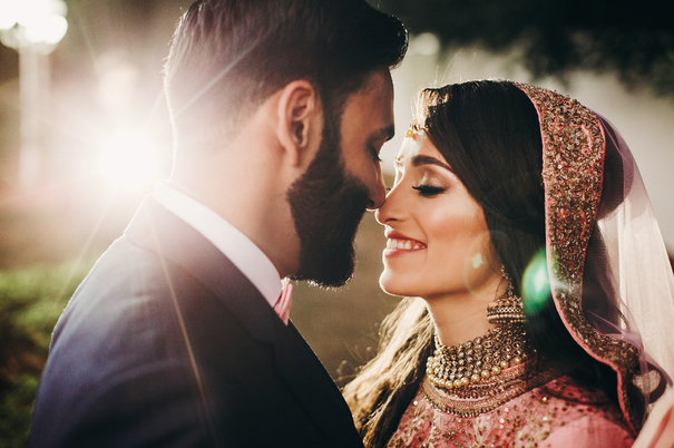 Newly married couple smiling during traditional indian wedding at Turning Stone Resort Casino 