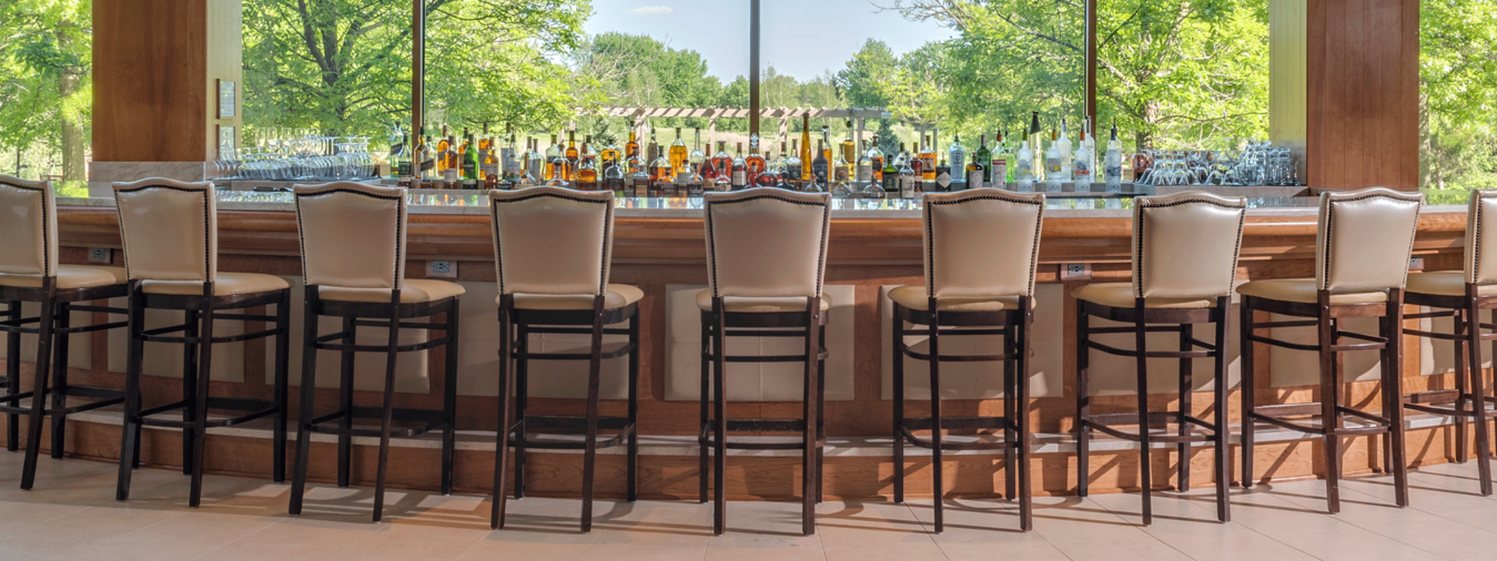 The bar in The Lodge Lounge looking over beautiful natural landscape