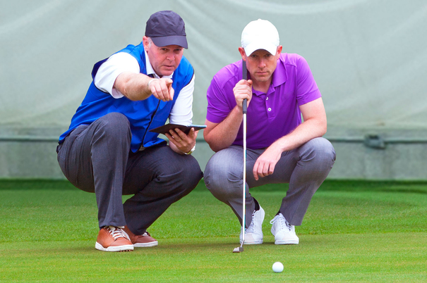 Private golf instructor giving lesson to student