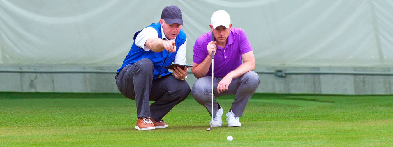 Private golf instructor giving lesson to student