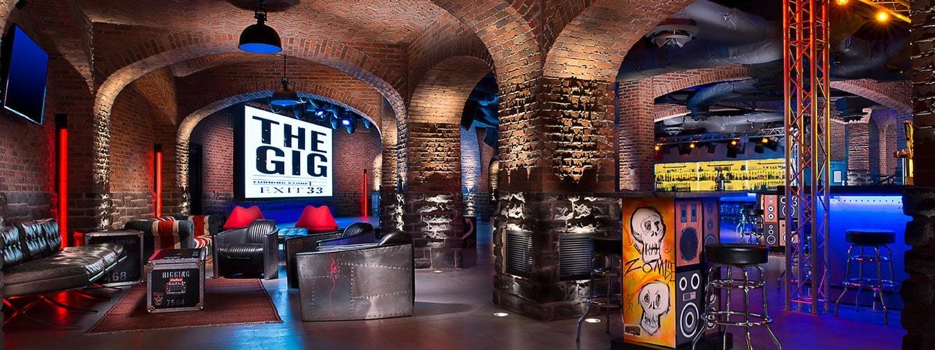 Inside of rock venue, The Gig at Exit 33 with brick archways and leather furniture