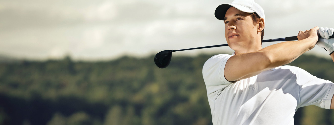 Golfer tracks his shot after swing