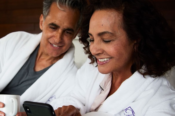 Man and woman in robes looking at the womans phone