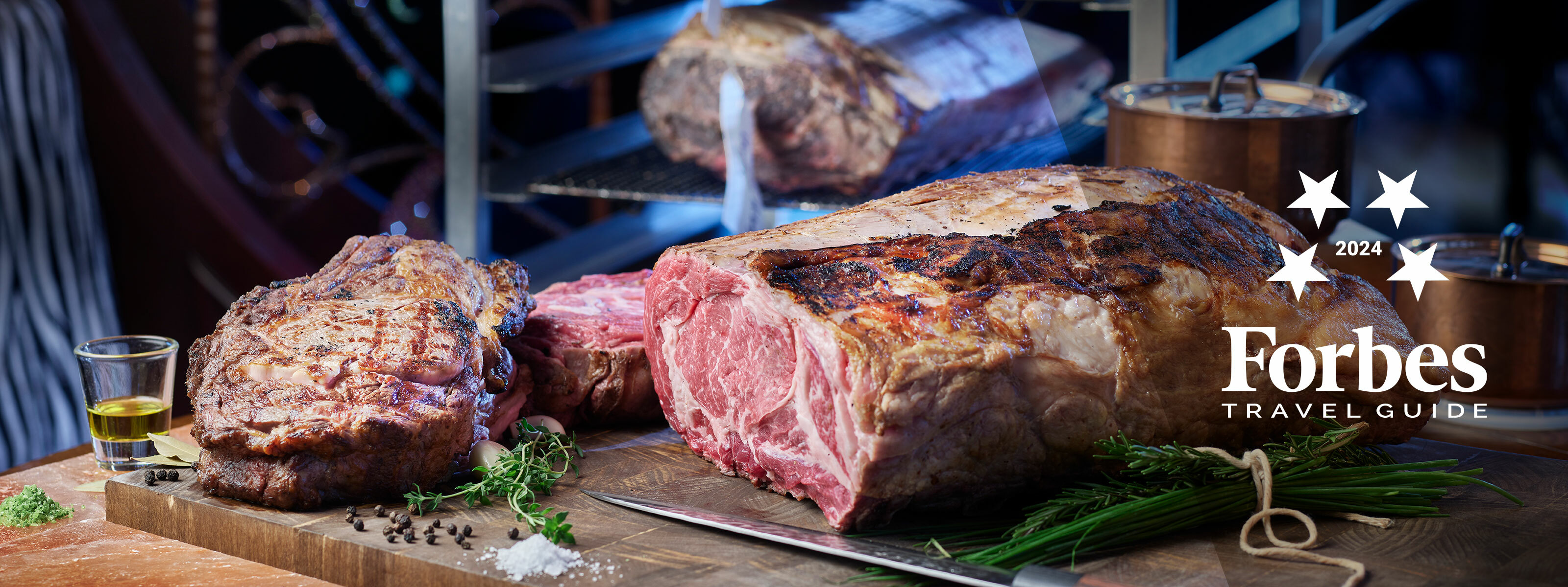 Sliced steak with seasoning and glass of oil