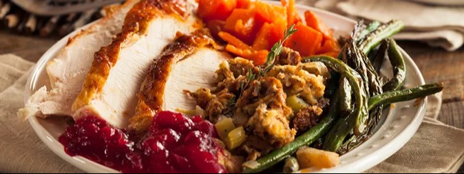 Thanksgiving Dinner with turkey, vegetables, stuffing, and cranberry sauce