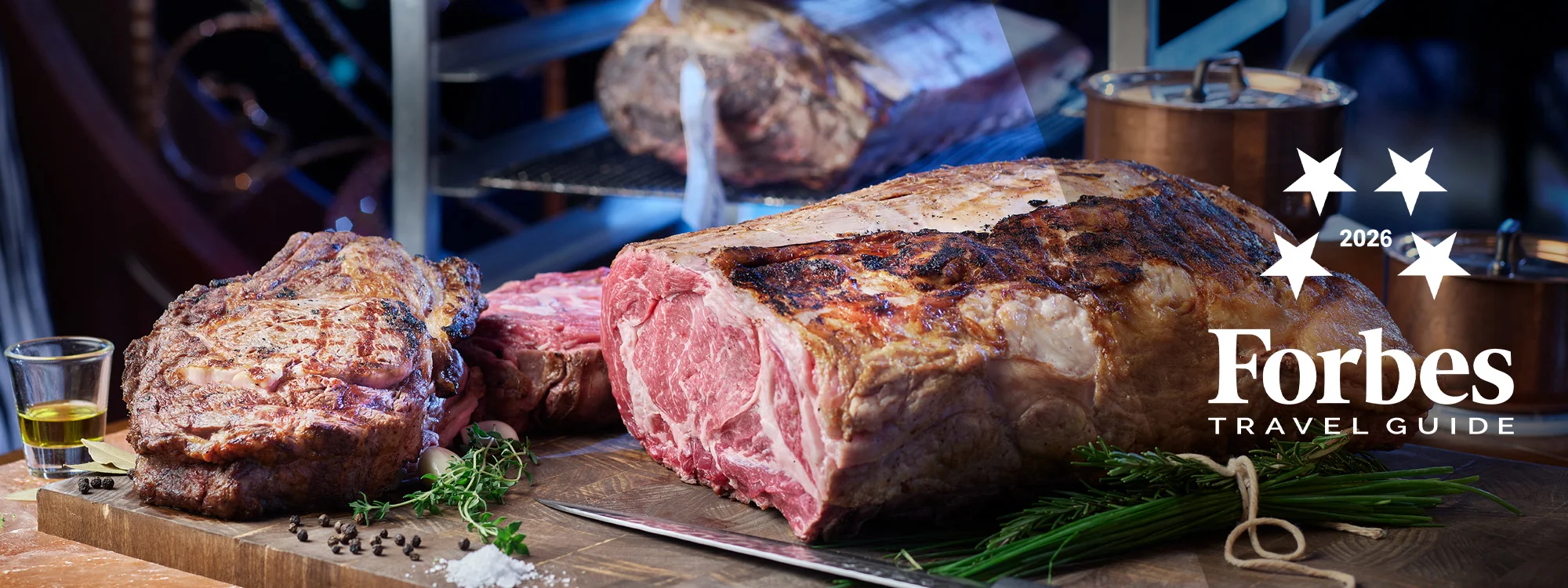 Sliced steak with seasoning and glass of oil