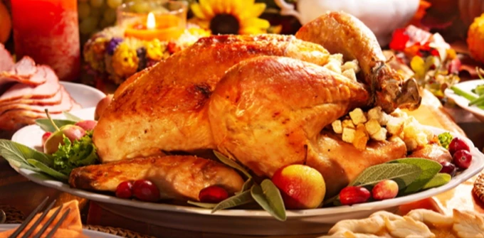 A Thanksgiving dinner spread, with turkey, ham, pie and other sides
