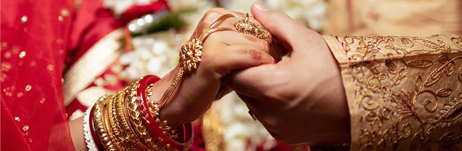 Traditional Indian wedding couple holding hands