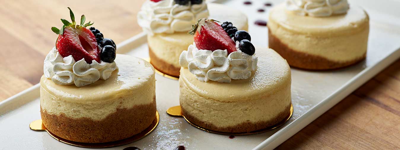 Cheesecake topped with whipped cream and mixed berries