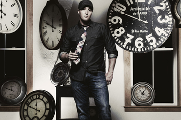 Travis Rocco Headshot Black and White with Clocks Background