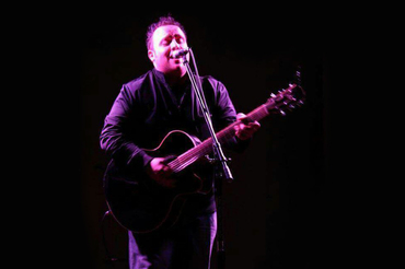Gary Johnson performing with guitar