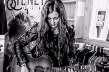 Sydney Irving playing guitar black and white