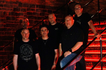 Under the Paige band photo with The Gig Stairs background