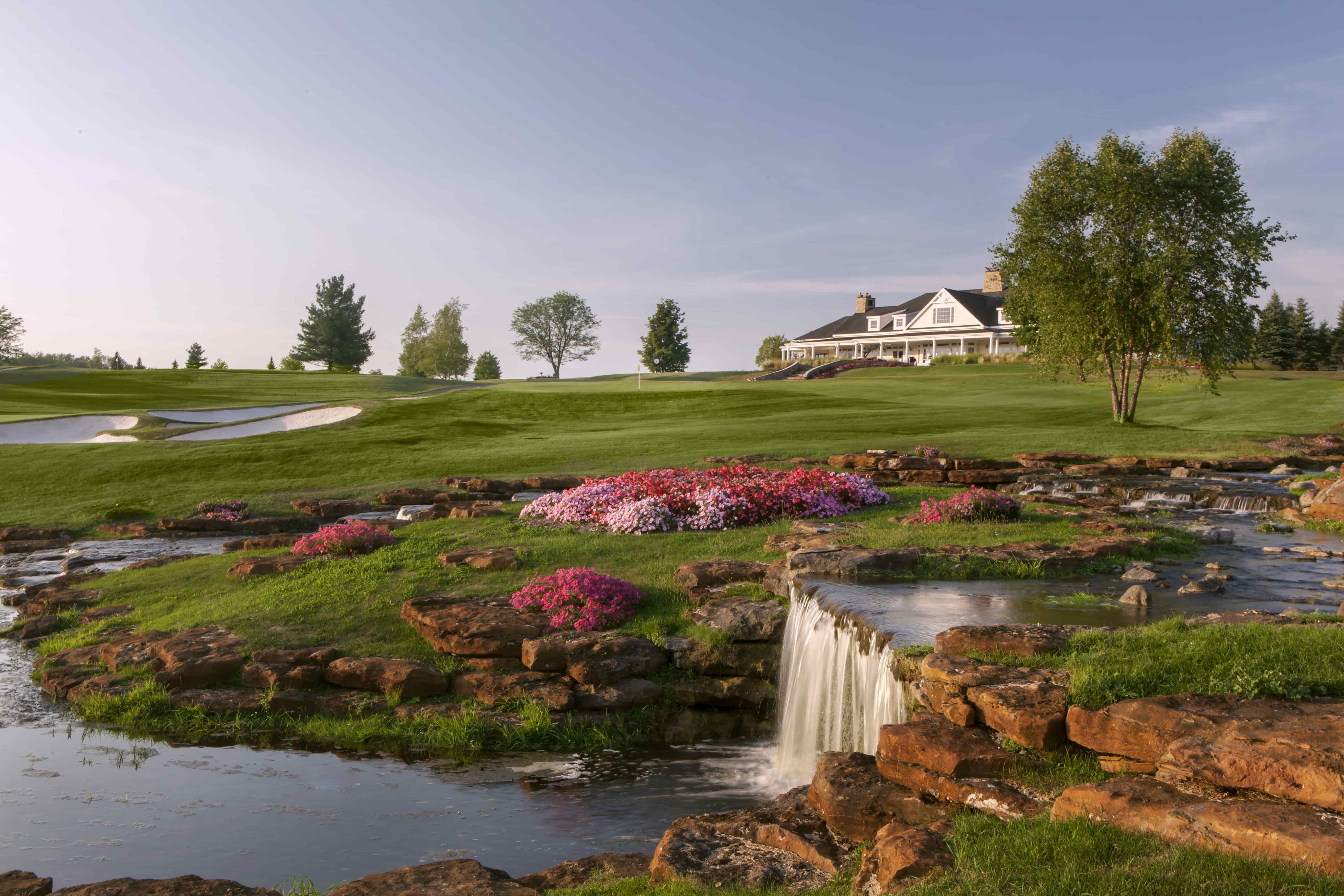 Flowing waterfall and wildflowers along the Atunyote Golf Course in Central New York