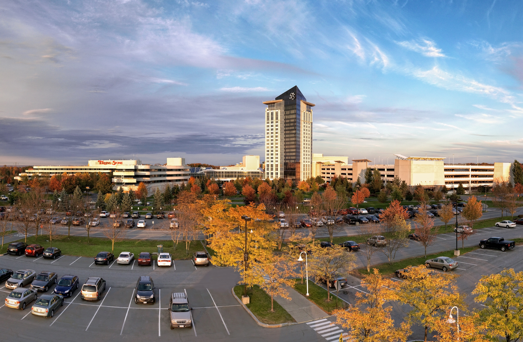 Panoramic shot of Turning Stone Resort Casino exterior with leaves changing colors in the fall