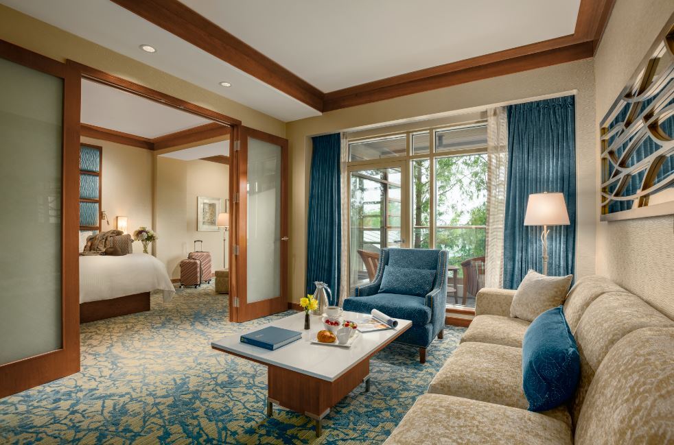image of redesigned suite at the lodge at turning stone with blue accent colors on carpet, chair, curtain and more