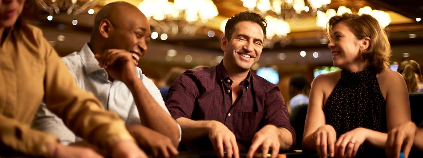Friends laughing at a poker table