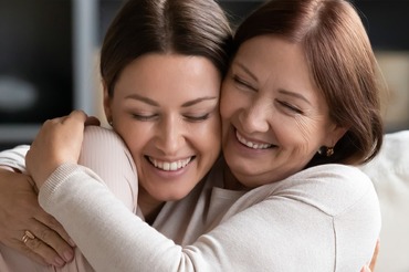 happy mother embraces daughter