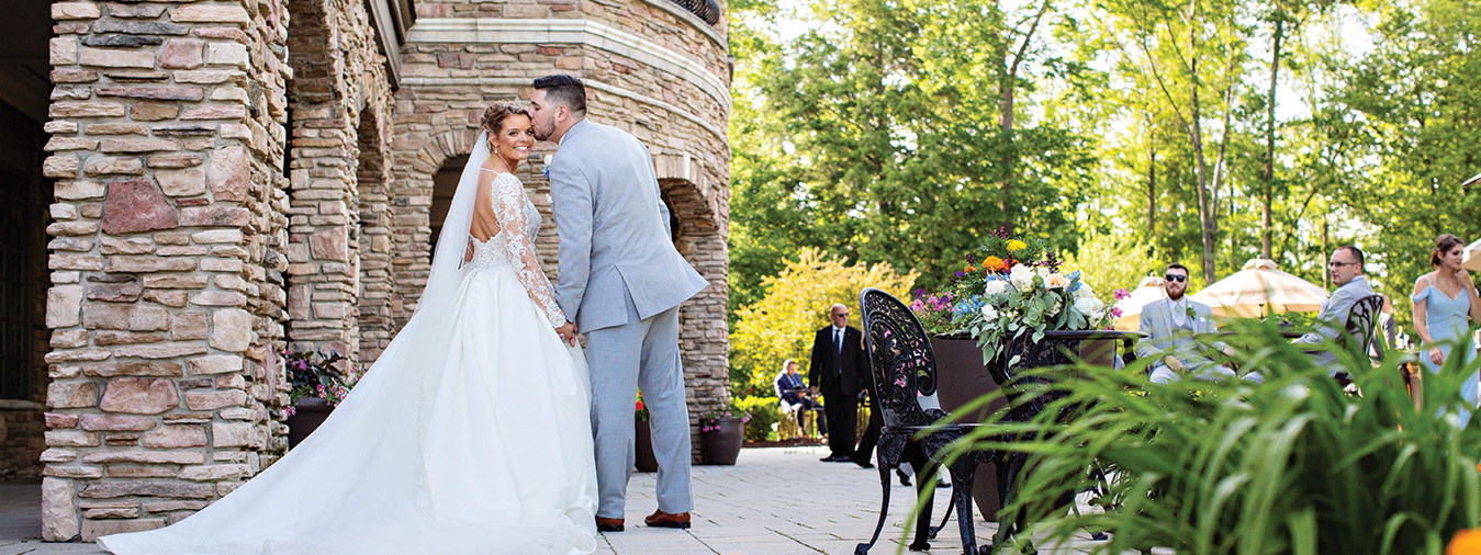 Bride and Groom posing on the Shenendoah Clubhouse Patio